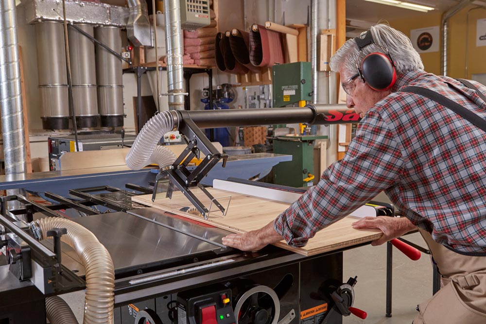 Man using SawStop 5hp Industrial Cabinet Saw w/36