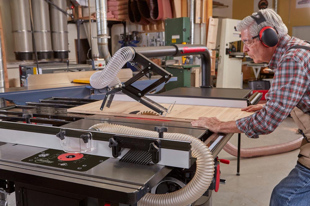 Man using SawStop 5hp Industrial Cabinet Saw w/36