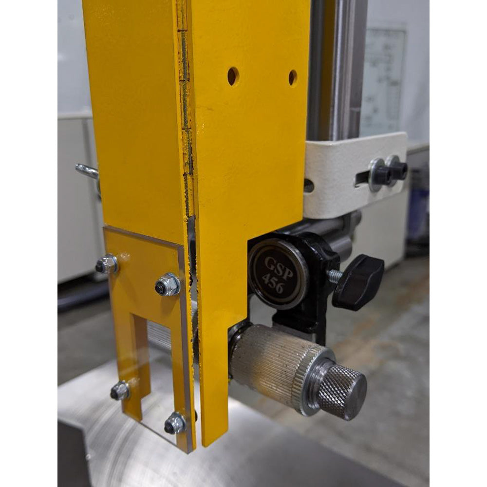 Upper blade guide assembly on the SCM Formula S 540P mounted to the yellow guide post with knurled adjustment knob and locking lever